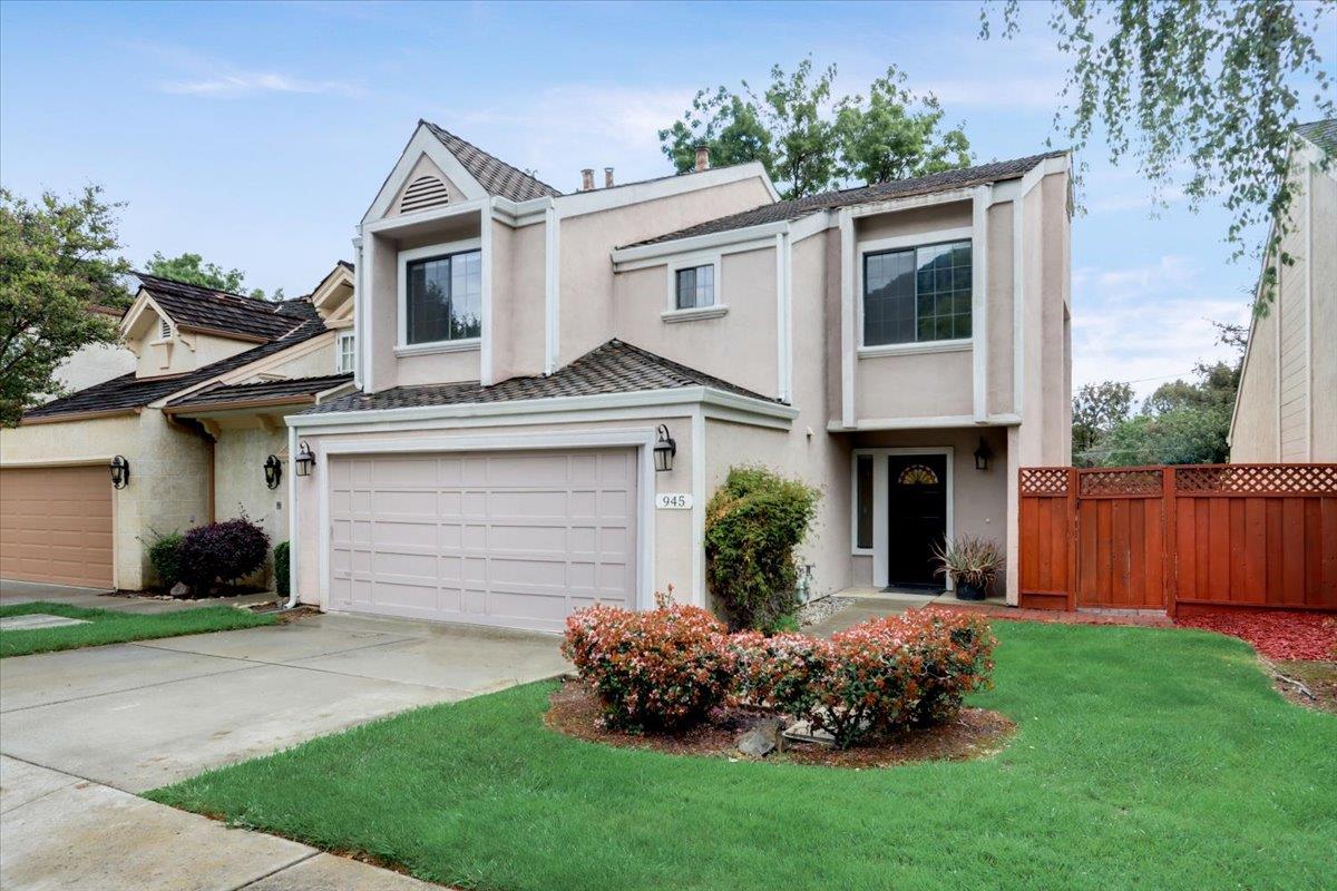 945 Oak Park Drive Morgan Hill, CA 95037 - Photo 1 of 46 a front view of a house with a garden and yard