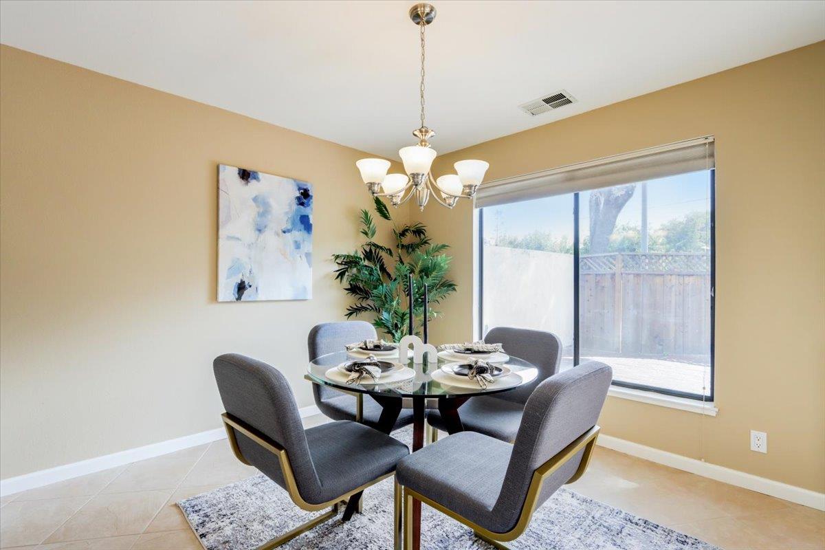 945 Oak Park Drive Morgan Hill, CA 95037 - Photo 11 of 46 a dining room with furniture a potted plant and a chandelier