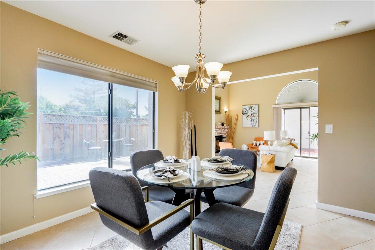 945 Oak Park Drive Morgan Hill, CA 95037 - Photo 12 of 46 a dining room with furniture a chandelier and window