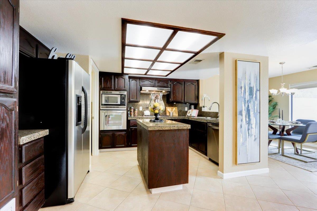 945 Oak Park Drive Morgan Hill, CA 95037 - Photo 15 of 46 a kitchen with a refrigerator and a stove