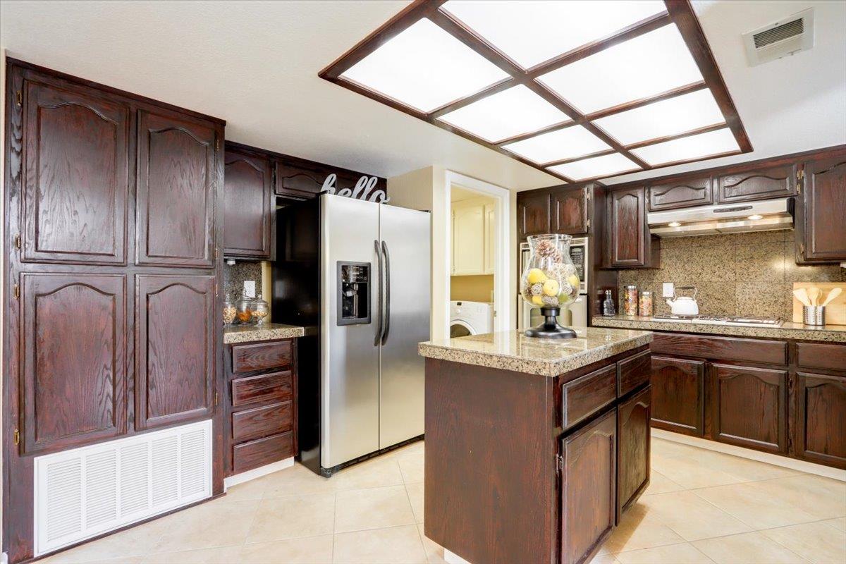 945 Oak Park Drive Morgan Hill, CA 95037 - Photo 16 of 46 a kitchen with stainless steel appliances granite countertop a refrigerator and a sink