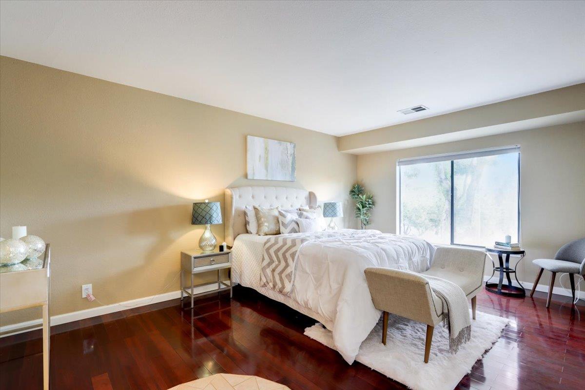 945 Oak Park Drive Morgan Hill, CA 95037 - Photo 24 of 46 a bedroom with a bed and wooden floor