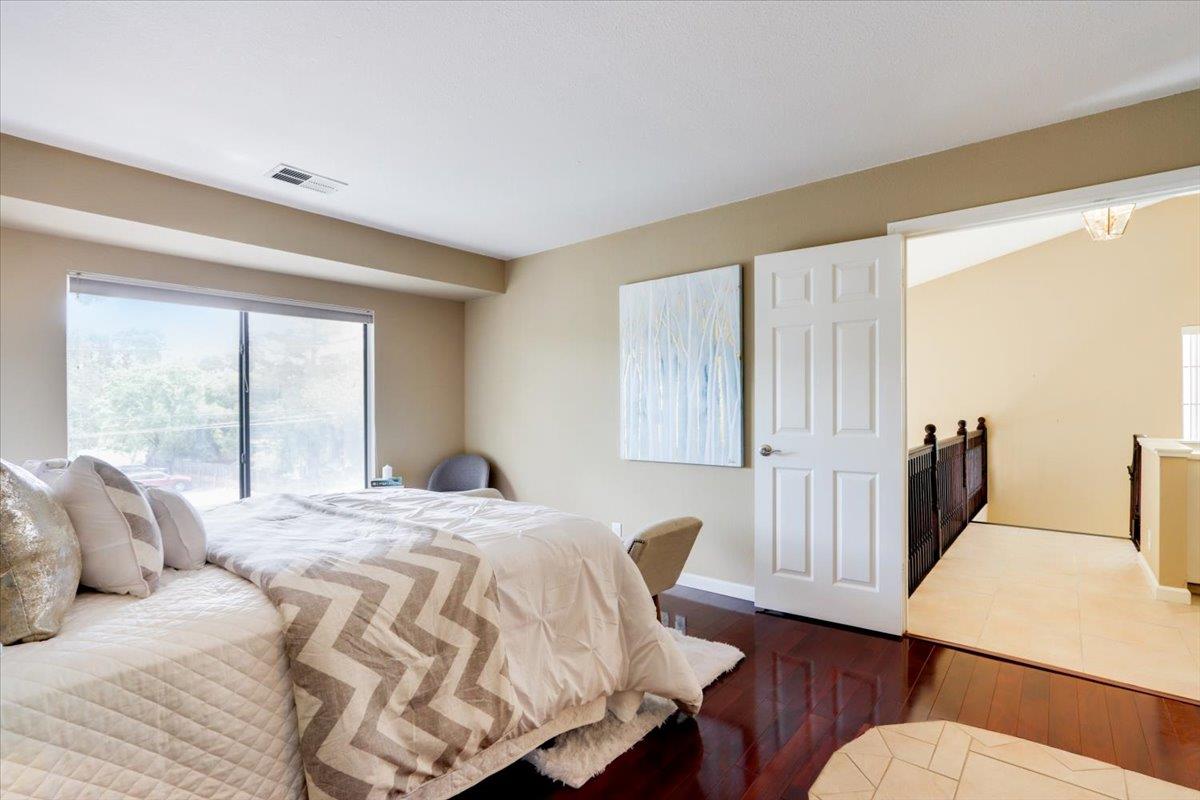 945 Oak Park Drive Morgan Hill, CA 95037 - Photo 25 of 46 a bed sitting in a bedroom next to a window