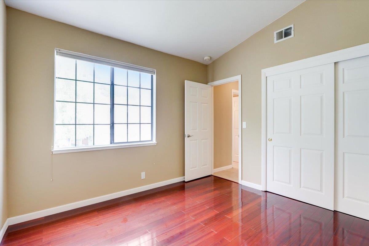 945 Oak Park Drive Morgan Hill, CA 95037 - Photo 31 of 46 an empty room with wooden floor and windows