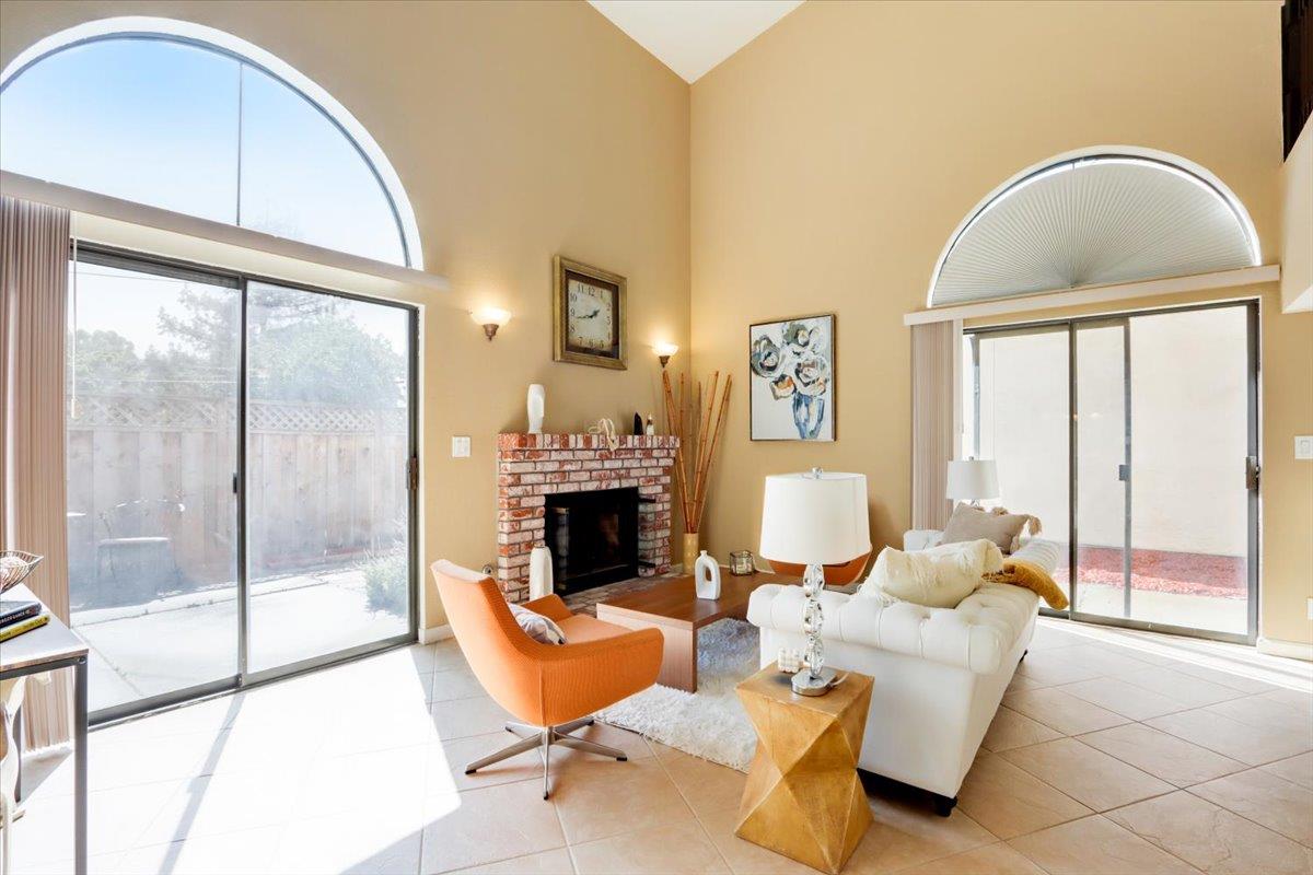 945 Oak Park Drive Morgan Hill, CA 95037 - Photo 7 of 46 a living room with furniture a large window and a chandelier