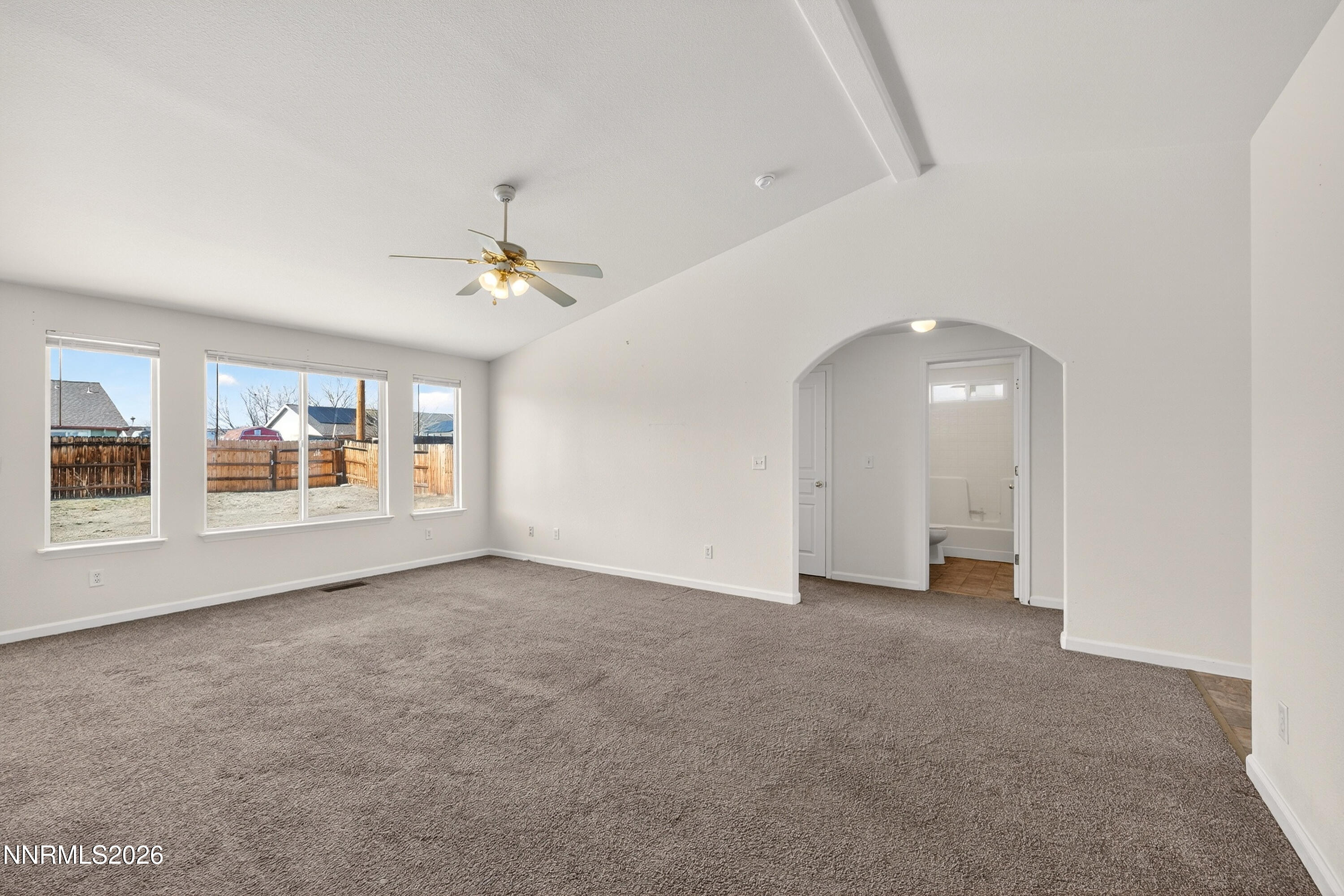 1222 Eagle Rock Road Fallon, NV 89406 - Photo 5 of 27 an empty room with chandelier fan and windows
