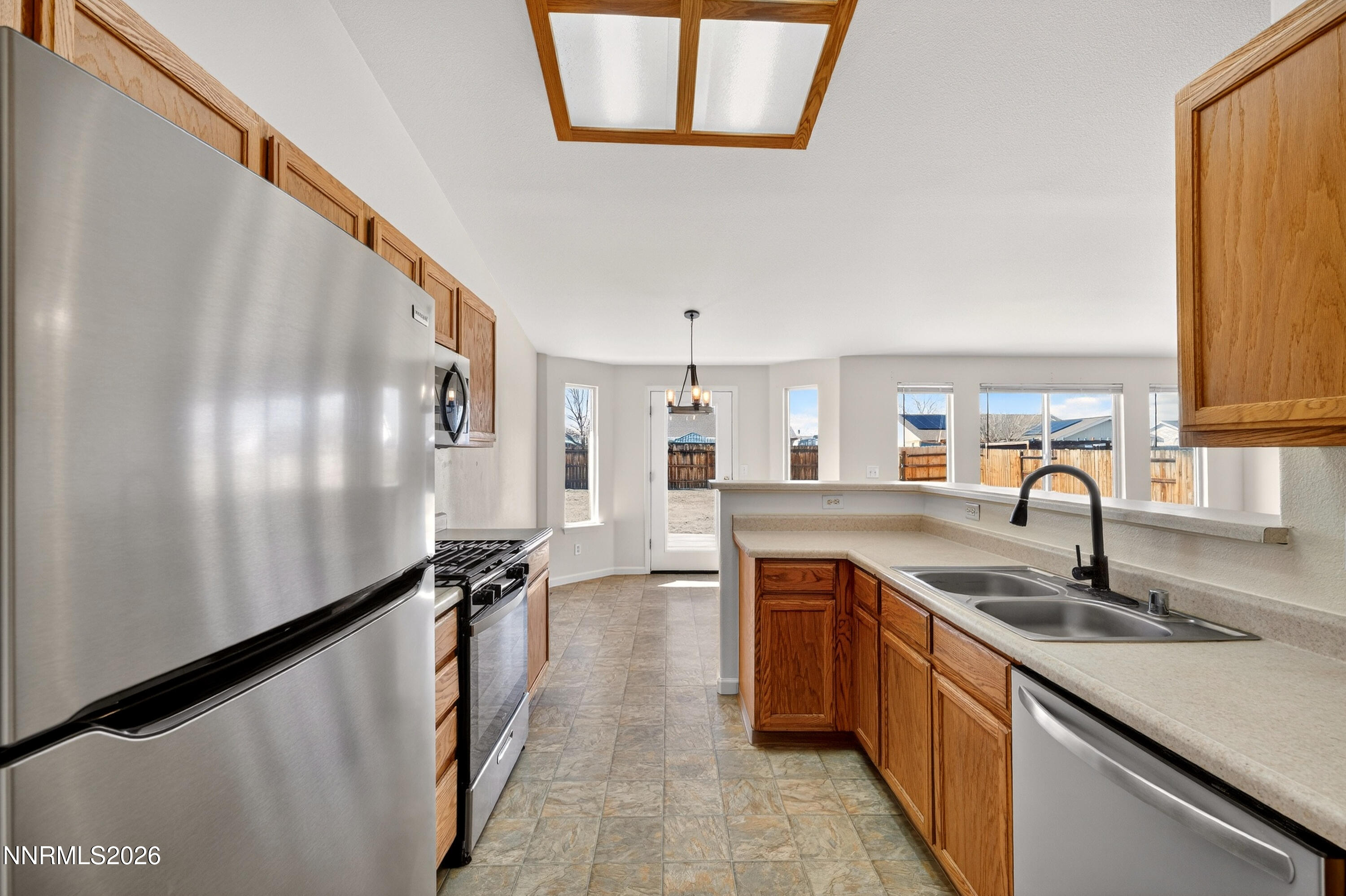 1222 Eagle Rock Road Fallon, NV 89406 - Photo 7 of 27 a kitchen with stainless steel appliances granite countertop a sink and a refrigerator