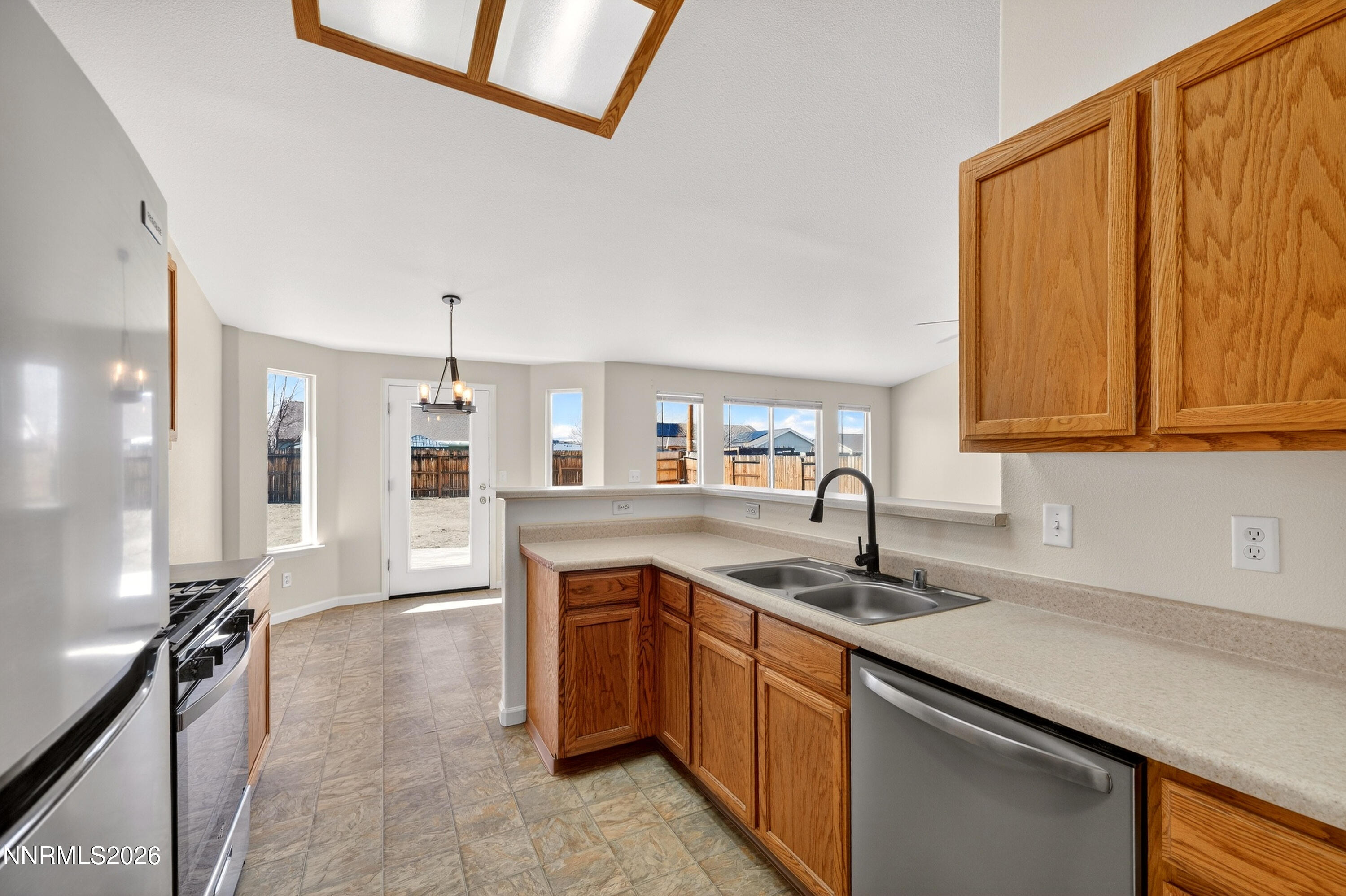 1222 Eagle Rock Road Fallon, NV 89406 - Photo 9 of 27 a kitchen with stainless steel appliances granite countertop a sink stove and refrigerator