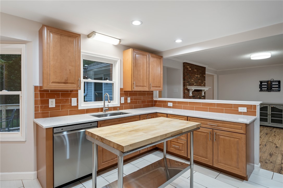 1014 East Queen Street Pendleton, SC 29670 - Photo 13 of 43 A well-equipped kitchen features ample cabinet space, a practical island, and resilient tile flooring.