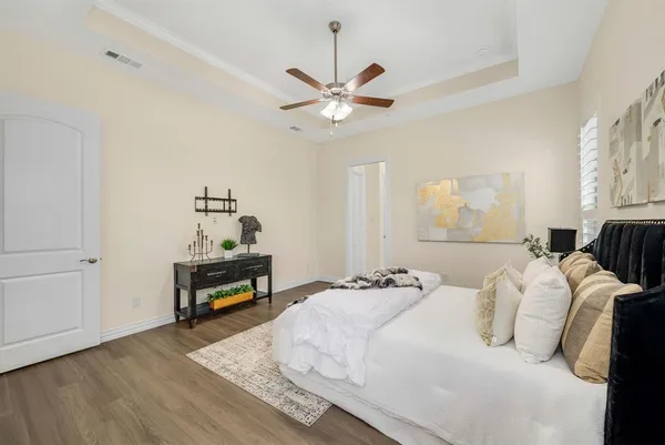 a bedroom with a bed and a chandelier