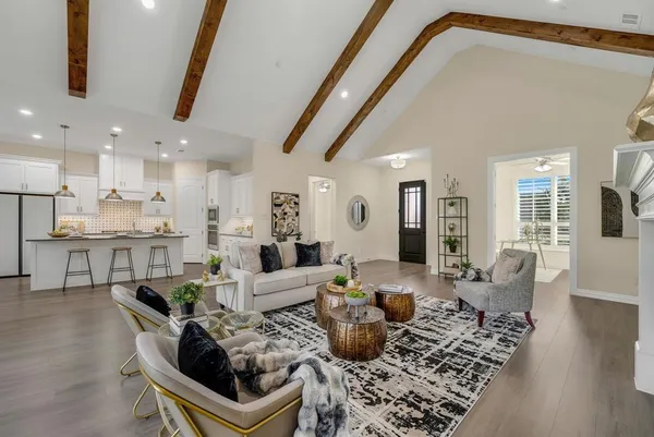 a living room with furniture and kitchen view