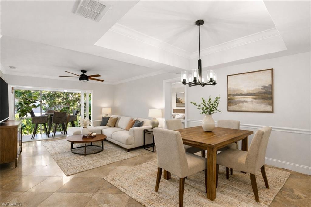 a living room with furniture a window and a chandelier