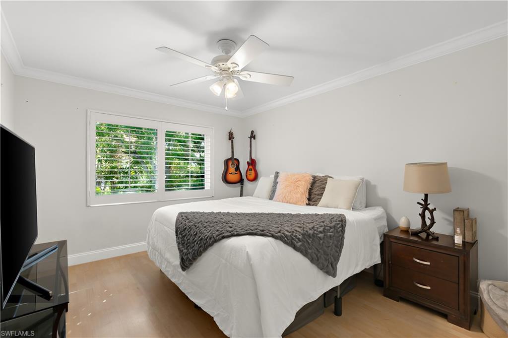 27 Watercolor Way, Unit 27 Naples, FL 34113 - Photo 17 of 36 a spacious bedroom with a large bed and a chandelier