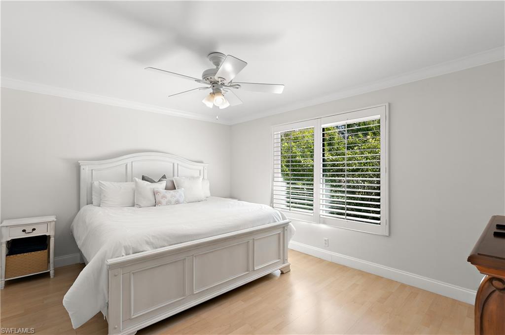 27 Watercolor Way, Unit 27 Naples, FL 34113 - Photo 21 of 36 a bedroom with a bed and a window