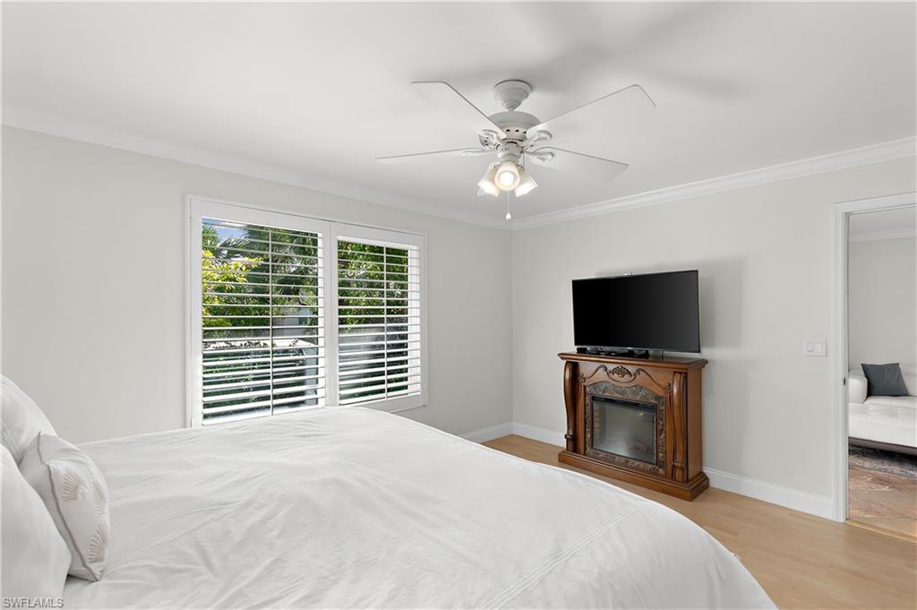 27 Watercolor Way, Unit 27 Naples, FL 34113 - Photo 22 of 36 a bedroom with a bed and a flat screen tv