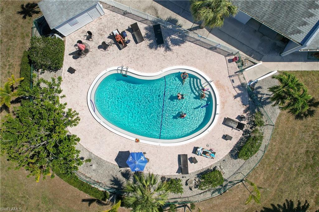 27 Watercolor Way, Unit 27 Naples, FL 34113 - Photo 28 of 36 an aerial view of a swimming pool with a yard and outdoor seating