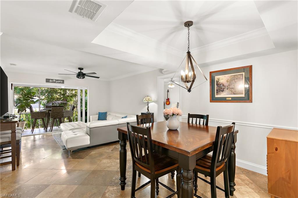 27 Watercolor Way, Unit 27 Naples, FL 34113 - Photo 7 of 36 a view of a dining room with furniture window and wooden floor