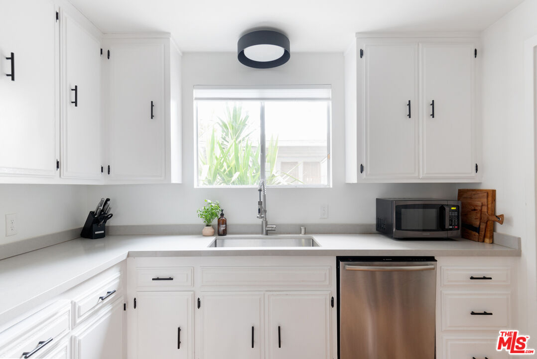708 South Cedar Street Glendale, CA 91205 - Photo 22 of 38 a kitchen with cabinets appliances a sink and a window