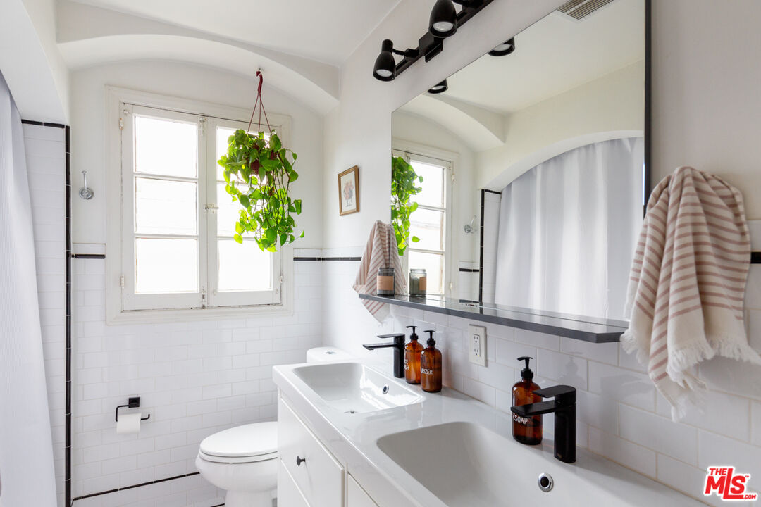 708 South Cedar Street Glendale, CA 91205 - Photo 25 of 38 a bathroom with a sink a toilet and a mirror