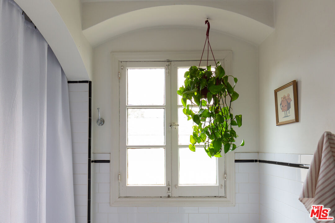 708 South Cedar Street Glendale, CA 91205 - Photo 26 of 38 a vase of flowers sitting on a floor next to a window