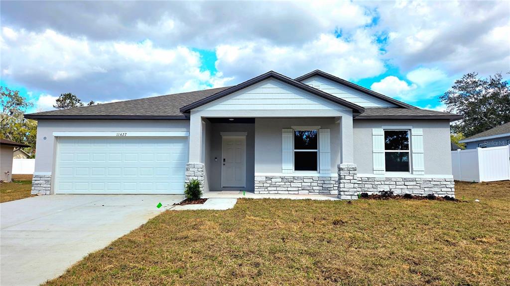 11427 Pickford Street Spring Hill, FL 34609 - Photo 1 of 1 a front view of house with yard