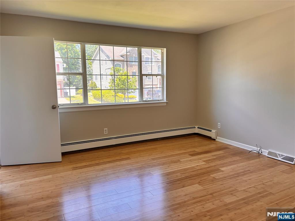21 Wanamaker Avenue, Unit 1 Waldwick, NJ 07463 - Photo 2 of 13 an empty room with wooden floor and windows