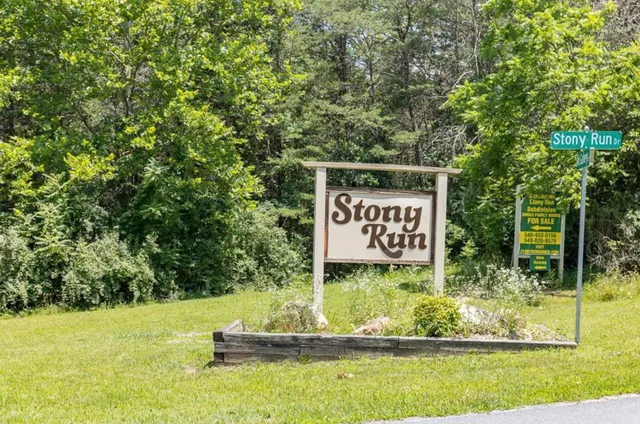 an aerial view of a house with garden space and mountains