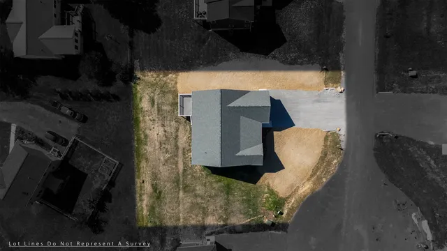 an aerial view of a houses with a yard