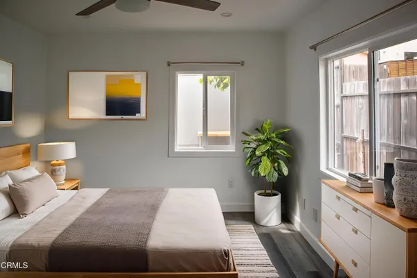 a bedroom with a bed and a potted plant
