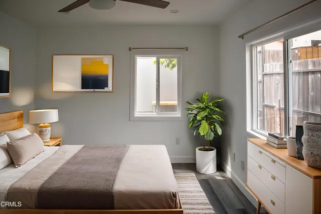 a bedroom with a bed and a potted plant