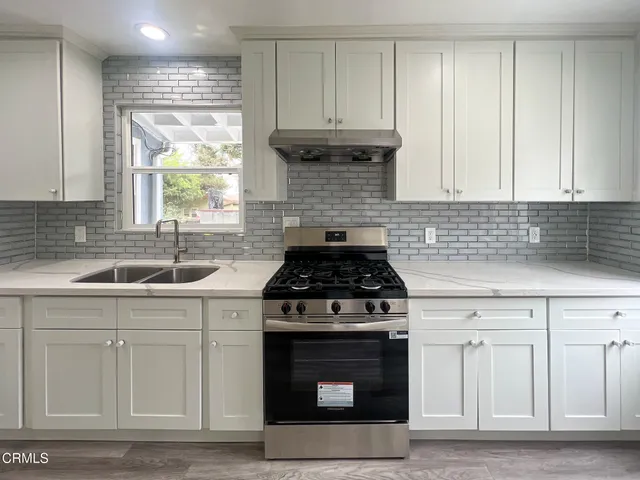 a kitchen with cabinets appliances and a sink