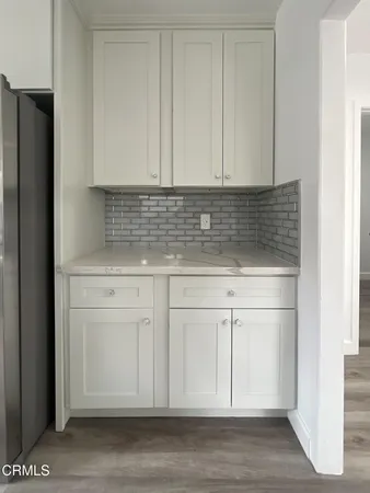 a view white cabinets and a wooden floor