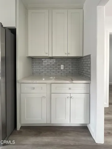a view white cabinets and a wooden floor