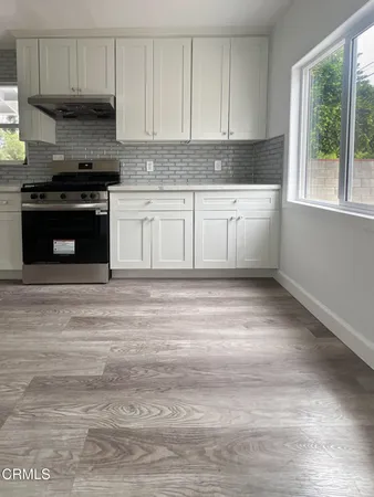 a kitchen with a stove a sink and a microwave