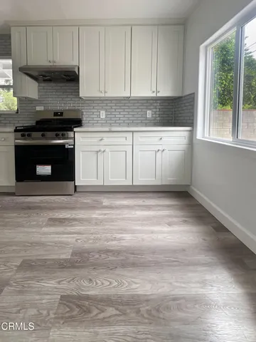 a kitchen with a stove a sink and a microwave