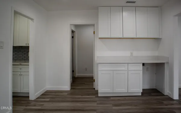 a view of cabinets and wooden floor