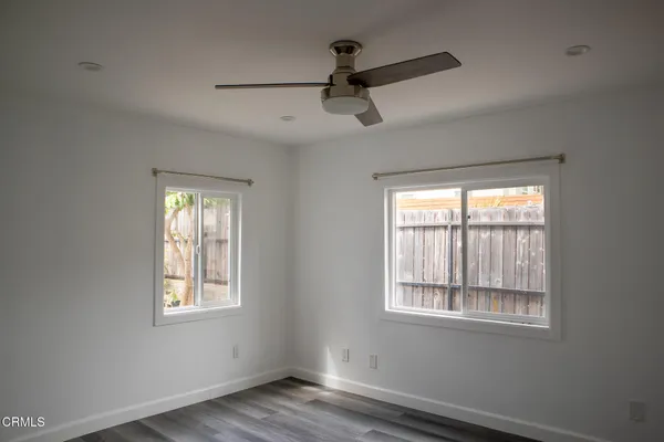 a view of a room with wooden floor and a window