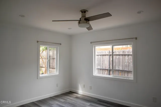 a view of a room with wooden floor and a window