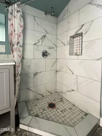 a view of backyard and wooden fence