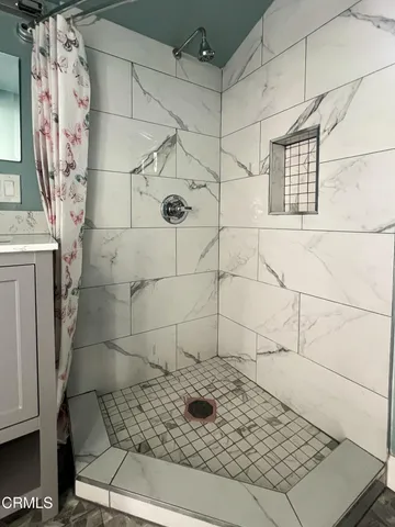 a view of backyard and wooden fence