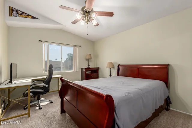 a bedroom with a bed and a desk