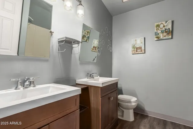 a bathroom with a sink toilet and mirror