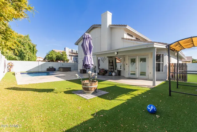 a view of a house with swimming pool and sitting area