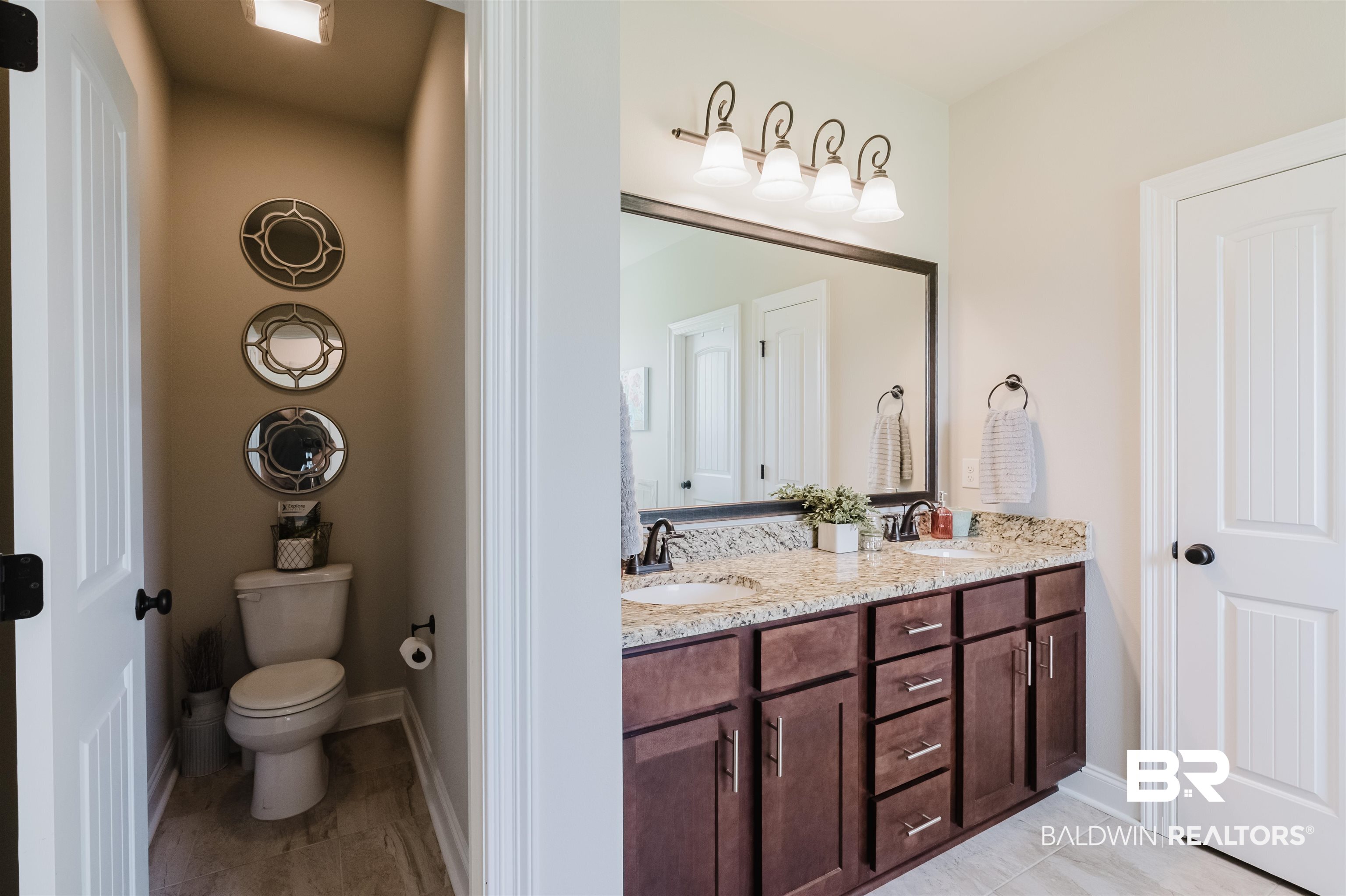12128 Red Barn Road Fairhope, AL 36532 - Photo 23 of 47 Bathroom with double vanity, tile patterned flooring, toilet, and baseboards
