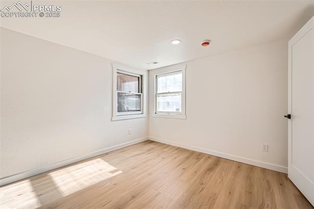 33 Cherokee Road Manitou Springs, CO 80829 - Photo 23 of 37 Spare room with visible vents, light wood-style flooring, and baseboards