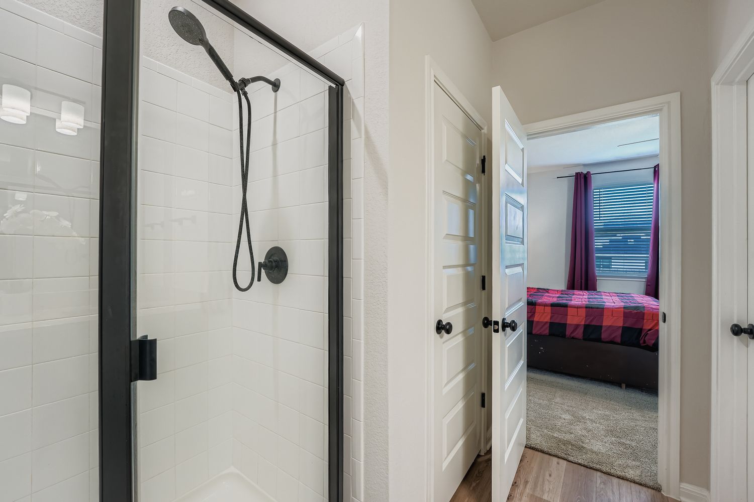 148 Gullivers Drive Elgin, TX 78621 - Photo 13 of 21 Full bathroom with a stall shower, ensuite bath, and light wood-style flooring