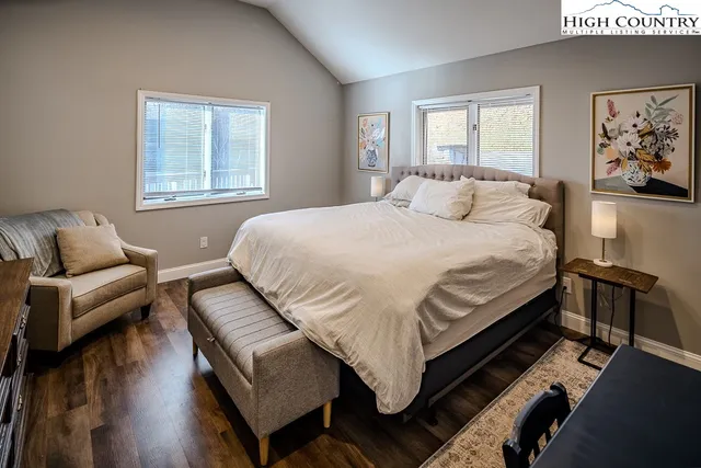 a bathroom with a granite countertop sink and a window