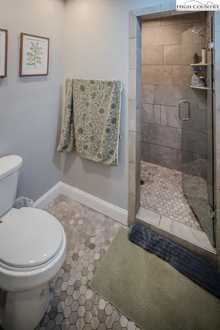 a bedroom with two beds and painting on the wall