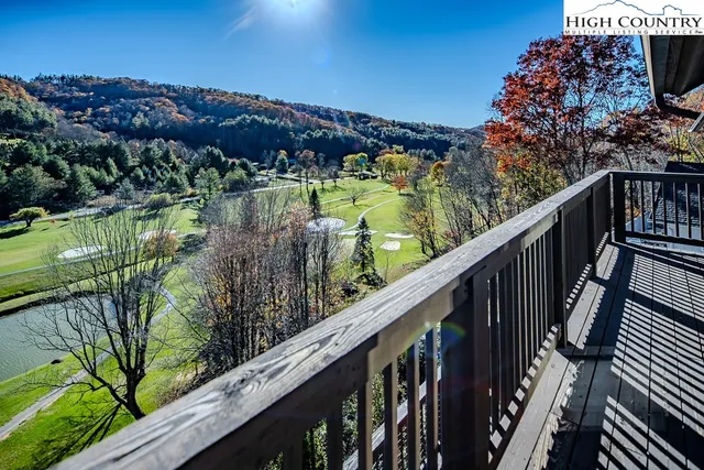 a living room with furniture pool table and a flat screen tv