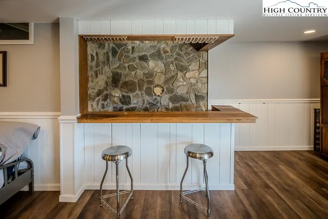 a view of a livingroom with furniture and wall paintings